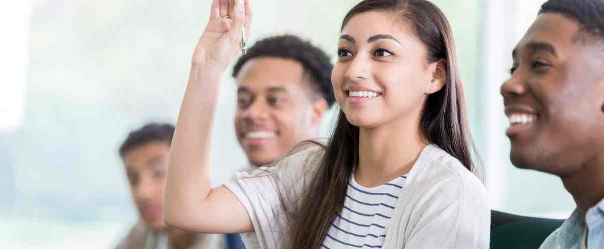 Woman raising her hand in class